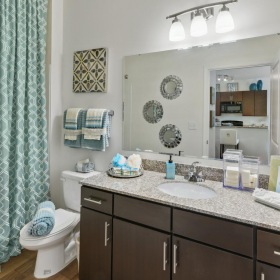 Bathroom options with thoughtful details a bathroom with a large mirror and modern fixtures